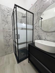 a bathroom with a sink and a mirror at Aura Maris in Guspini +39 photos