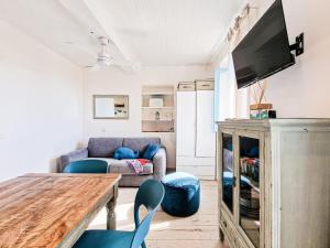 a living room with a couch and a table and chairs at Loft Azzurro Old City Center in Rio Marina