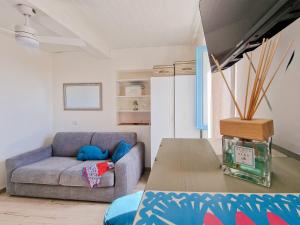 a living room with a couch and a table at Loft Azzurro Old City Center in Rio Marina +21 photos