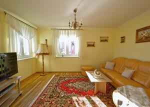 a living room with a couch and a table at Ferienhaus Weitblick in Dresden