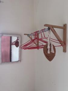a red rope hanging from a wall next to a mirror at Casa Tota in Assomada