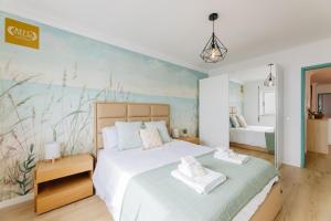 a bedroom with a bed with two towels on it at BESTVILLAS Âncora Rio in Vila Praia de Âncora