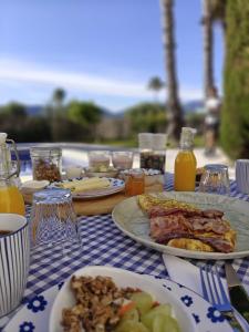 a table topped with plates of food and drinks at B&B Casa Ellie in Tormos