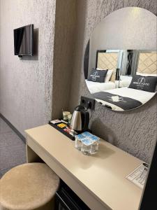 a room with a table and a mirror at Divan Tower Otel in Erzurum