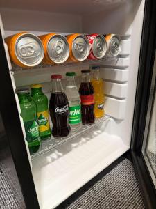 a refrigerator filled with different types of soda at Divan Tower Otel in Erzurum