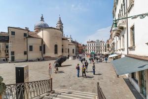 a group of people walking around a city street at Rigoletto Apartments by Fenix in Venice