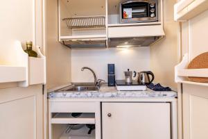 a kitchen with a sink and a microwave at Rigoletto Apartments by Fenix in Venice