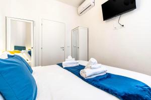 a bedroom with a bed with towels on it at Rigoletto Apartments by Fenix in Venice