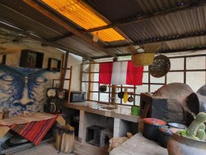 a kitchen with a stove in a room with windows at Coco's vibes in Ollantaytambo