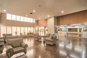 a lobby with couches and chairs in a building at Apartamentos Resitur in Seville