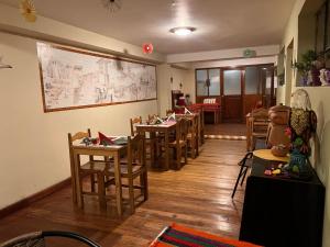 a dining room with wooden tables and chairs at Killaqente in Cusco