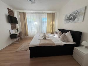 a bedroom with a large bed in a room at Lemsdorfer Apartments Magdeburg in Magdeburg