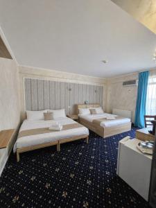 a hotel room with two beds in a room at Armsea Mamaia Nord in Mamaia Sat/Năvodari +26 photos