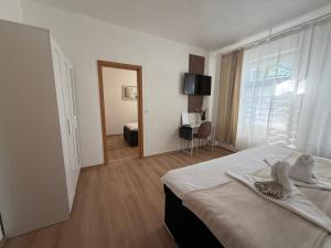 a hotel room with a bed and a window at Lemsdorfer Apartments Magdeburg in Magdeburg