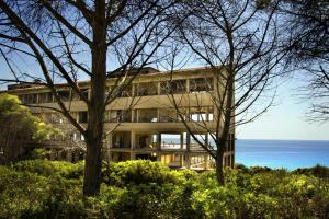a large building with the ocean in the background at Aura Maris in Guspini