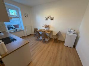 a kitchen and dining room with a table and chairs at Lemsdorfer Apartments Magdeburg in Magdeburg