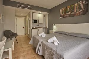 a bedroom with a bed with towels on it at Apartamentos Resitur in Seville +36 photos