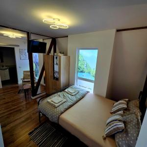 a room with a bed and a large window at Wood Nest in Bragadiru +60 photos