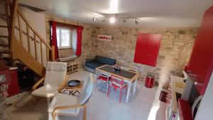 a kitchen with a table and chairs and a couch at La Maison du Cros in Cassagnes-Bégonhès