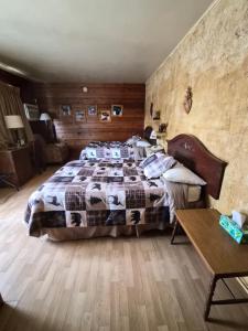 a bedroom with a bed and a wooden wall at Chateau Lodge in Oregon