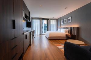 a bedroom with a bed and a living room at Ambulan Mexico City in Mexico City