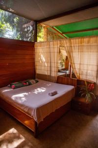 a bedroom with a bed in a tent at Coco house tambopata in Puerto Maldonado