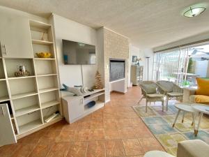 a living room with a tv and a couch and a table at Sand And Sea Self Catering #3 in Swakopmund
