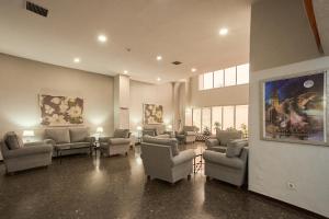 a waiting room with couches and chairs in a building at Apartamentos Resitur in Seville