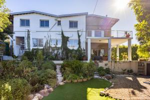 a house with a garden in front of it at New Mountain Retreat with Scenic Views in Hout Bay