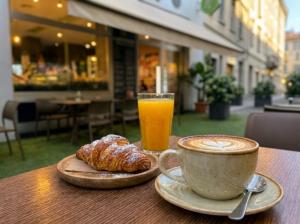 a cup of coffee and a croissant and a glass of orange juice at AH - Collezione Brera in Milan