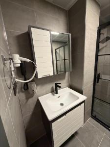 a bathroom with a sink and a mirror and a shower at Divan Tower Otel in Erzurum +17 photos