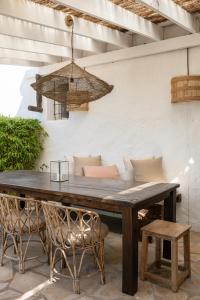 a wooden table and chairs on a patio at Hotel Can Sastre in Santa Gertrudis de Fruitera