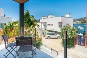 a glass table and a chair on a balcony with a view at Can Olivera in Nuestra Señora de Jesus