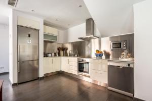 a kitchen with white cabinets and stainless steel appliances at Can Olivera in Nuestra Señora de Jesus