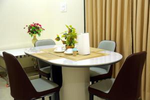 a table in a room with chairs around it at Elite Residency Bhadrachalam in Bhadrāchalam +9 photos