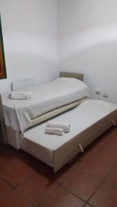 a bed in a room with two towels on it at Casa Fauna in Mendiolaza