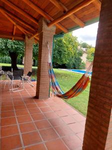 a hammock on a patio with a pool at Casa Fauna in Mendiolaza
