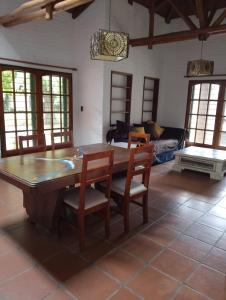 a dining room with a large wooden table and chairs at Casa Fauna in Mendiolaza