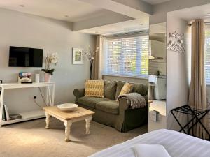 a living room with a couch and a table at THE STUDIO MAIDENHEAD RIVERSIDE in Maidenhead