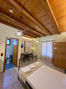 a bedroom with a large bed and a desk at Kyriakos Apartments in Politika