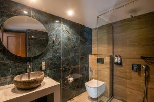 a bathroom with a sink and a glass shower at Eleni Beach Apartment in Stalís +26 photos