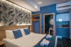 a bedroom with a bed with two towels on it at Eleni Beach Apartment in Stalís