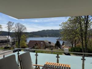 a view of a lake from the balcony of a house at Lakeview Residence in Schluchsee