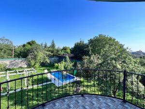 a balcony with a view of a swimming pool at Mountain View Deluxe Villa & pool in Gabala