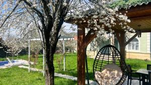 a gazebo with a table and chairs and a tree at Mountain View Deluxe Villa & pool in Gabala