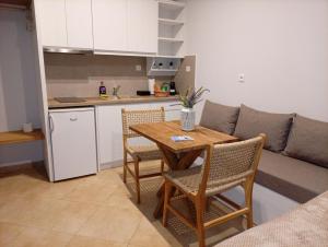 a living room with a table and chairs and a couch at Themonia Studios Kimolos in Kimolos