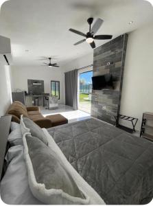 a living room with a bed and a flat screen tv at El Retiro Villas & Pádel - Villa 3 in Parras de la Fuente