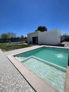 a swimming pool in front of a house at El Retiro Villas & Pádel - Villa 3 in Parras de la Fuente