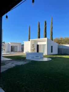a white house with trees in the background at El Retiro Villas & Pádel - Villa 3 in Parras de la Fuente
