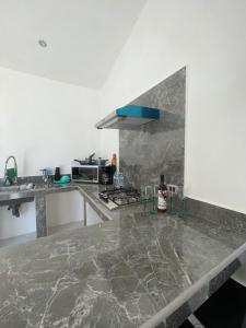 a kitchen with a marble counter top and a stove at El Retiro Villas & Pádel - Villa 3 in Parras de la Fuente